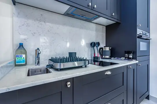 Modern kitchen with grey cabinets and clean worktops