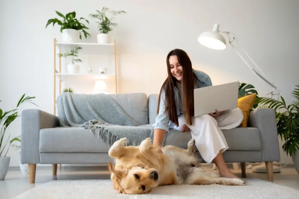 Woman sitting on sofa with dog